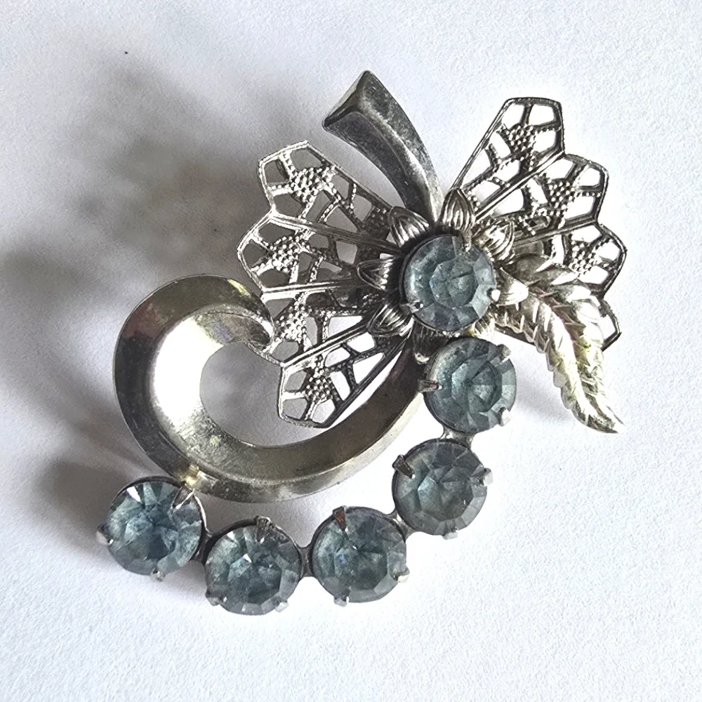 Vintage brooch pin pale blue rhinestones swirl filigree